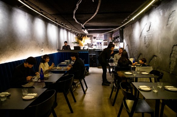 The 12-metre loop of halo lighting, blue velvet banquettes and distressed, charcoal-daubed walls at Soul Dining.