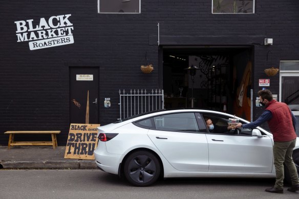 Spirited success: Black Market's Angus Nichol serves a customer at the drive-through.