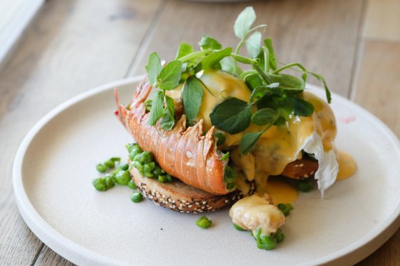 Butter-roasted lobster tail with poached eggs in a bagel.