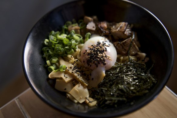 The original mazesoba includes chunks of house-made pork belly chashu, a runny onsen egg and a dusting of spring onion.