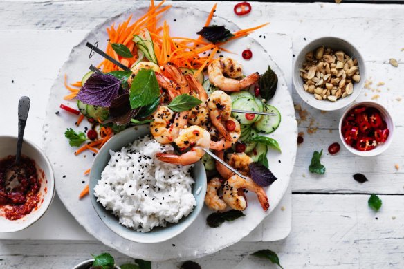 Coconut rice with quick pickled vegetables and prawn skewers.