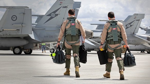 WAGES OF WAR: A RAAF Super Hornet crew prepare to depart to the Middle East.