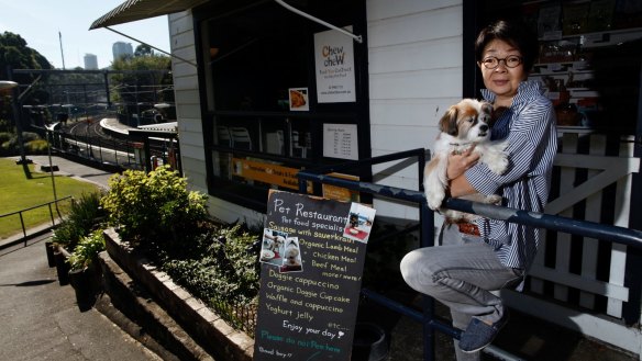 Naoko Okamoto with Douglas out front of Cafe Chew Chew Pet Restaurant, part of a growing trend of eateries catering for dogs. 