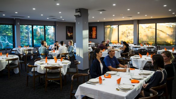 The venue, with glossy prints, white-clothed tables and Scandinavian chairs.