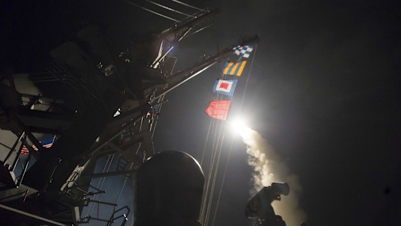 The guided-missile destroyer USS Ross fires a Tomahawk land attack missile towards Syria on April 7.