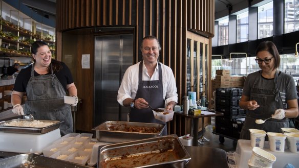 Neil Perry, packing the 200,000th meal for Hope Delivery, a tomato, cardamom and potato curry.