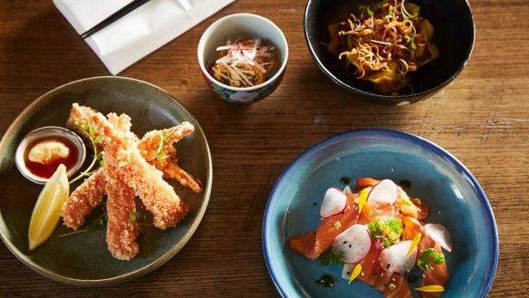 Clockwise from top right: seafood dumplings, salmon with pickled fennel and radish, crumbed prawns and house-made kimchi at Sakana.