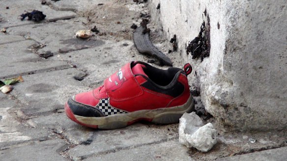The shoe of a young victim and a piece of metal lay near the scene just hours after Saturday's bomb attack in Gaziantep, southeastern Turkey, early on Sunday.