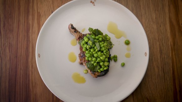 Cider-brined pork chop with squashed peas.
