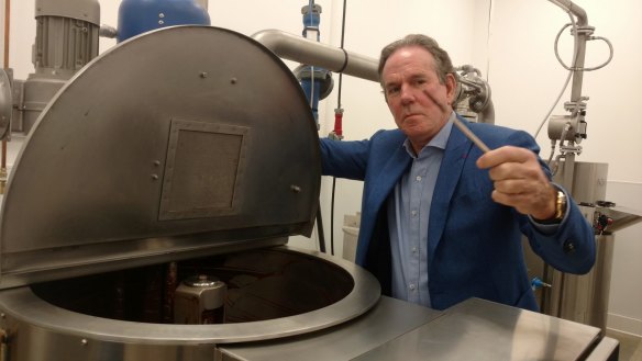 Thomas Keller dips into a chocolate vat at his California factory.