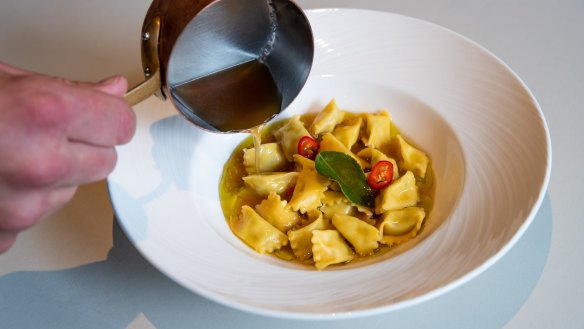 Small, well-formed agnolotti stuffed with spanner crab pivot from Italy to Thailand.