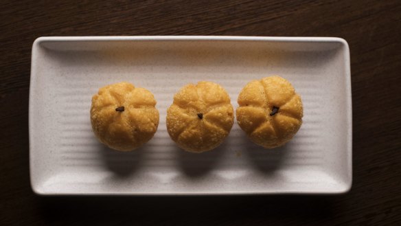 Halloween-orange pumpkin-shaped dumplings filled with mushroom and water chestnut.