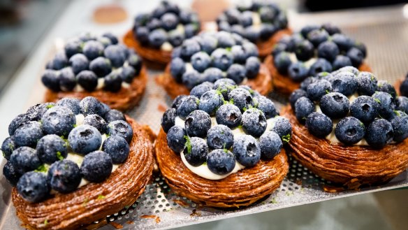 Blueberry tarts topped with a generous amount of berries.