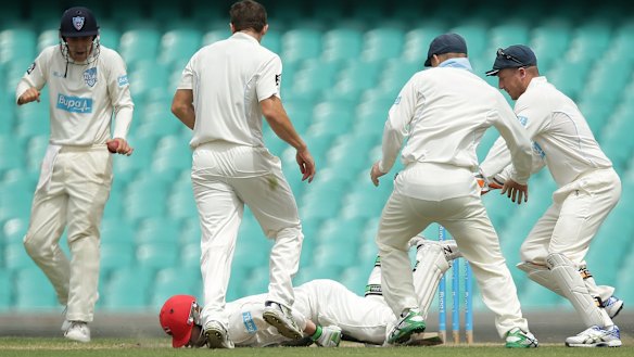 Hughes falls face down on the pitch.