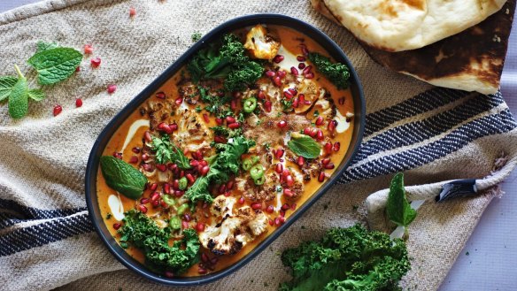 Garam masala roasted cauliflower in coconut and saffron curry with pomegranate and kale. Yes, it's vegan.