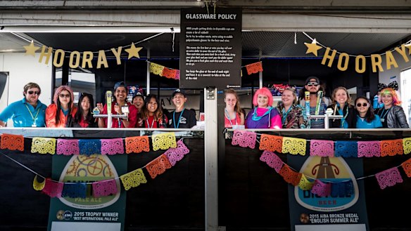 The bar staff in dress-up mode in cafe de canvas, a massive tent with a bar attached which travels with the ride.