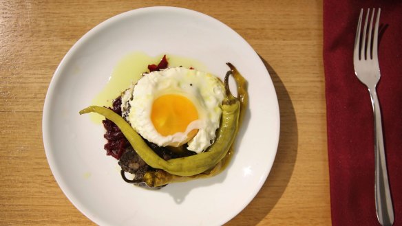 Pickled beetroot and fried egg dish.