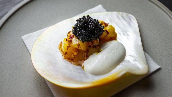 Scallop with oyster emulsion, marigold and caviar.