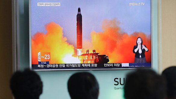 Anxious South Koreans watch footage of a North Korean ballistic missile launch last year
