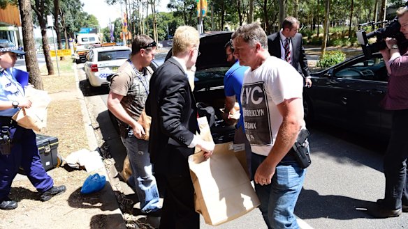 Police take evidence from an upmarket apartment at Sydney's Olympic Park on Tuesday.