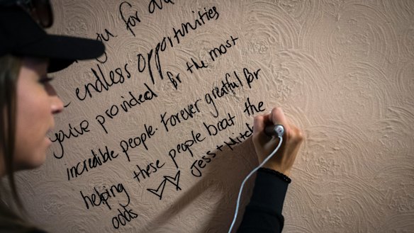 Jess Taylor, writes on the wall of The Gatwick at the open day on Saturday.