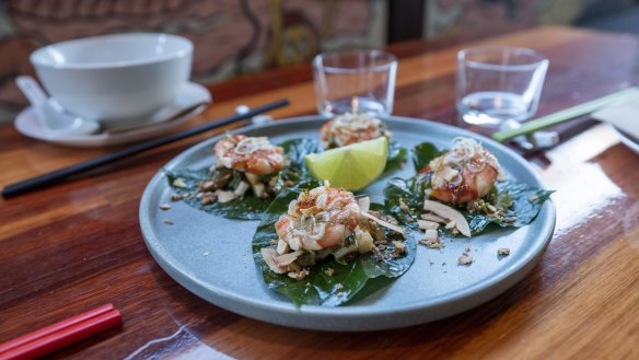 Miang kham, large betel leaves with a sweet, sour, spicy mix of prawns, jicama, coconut and peanuts.