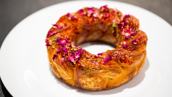 The Crown On 487 is a croissant-dough bracelet adorned with raspberry glaze, rose petals and pistachio crumbs.