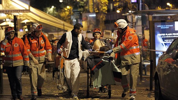 An injured person is evacuated from the Bataclan theatre.