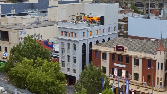 Her (centre) encompasses a five-storey building on Lonsdale Street.