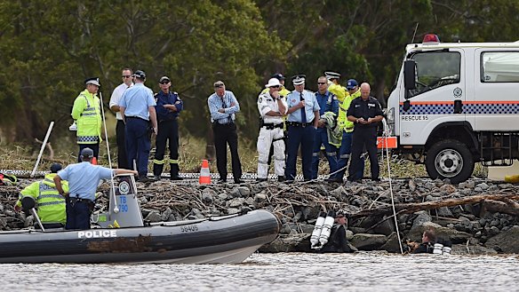 Two police divers at the accident scene on the Tweed River.