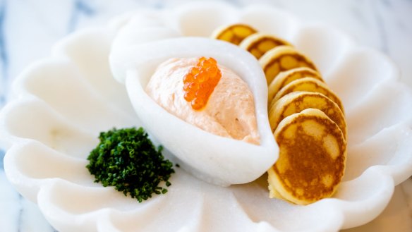 Pink tarama topped with salmon roe and served with blinis.