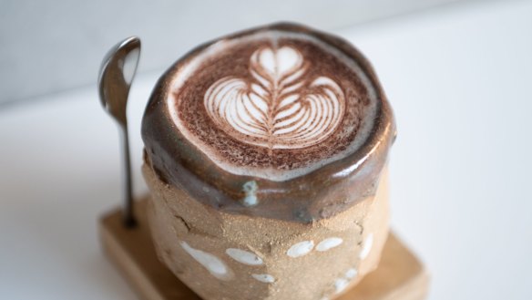 Black sesame latte with spoon stand.