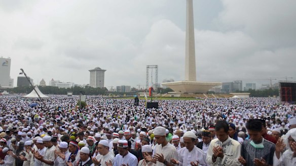 Tens of thousands take part in a prayer at Jakarta's National Monument during the December 2 rally against Jakarta's governor Ahok.