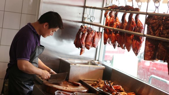 Roast ducks hanging in the window of Pacific Seafood BBQ House.