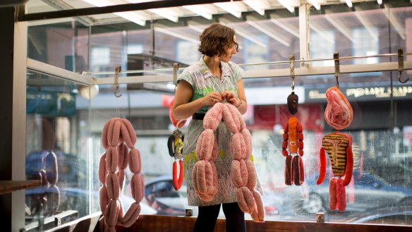 French meat dolls and knitted sausages adorn the window.