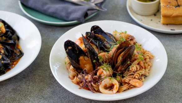 Spirali with mussel shells and fish pieces in fresh tomato sugo.