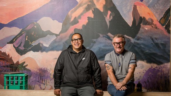 Morgan McGlone (left) and Michael Delaney in front of one of the murals inside Natural History. 