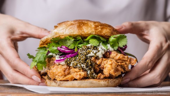 Fried buttermilk chicken on ciabatta with green chilli yoghurt, purple cabbage slaw, shallots and Black River Siberian Caviar.