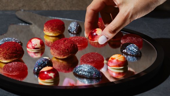 A selection of chocolate truffles at Aria, inspired by Acid.Flwrs' psychedelic botanical art.