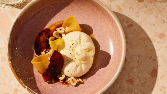 Burrata with charred peaches and hazelnut.