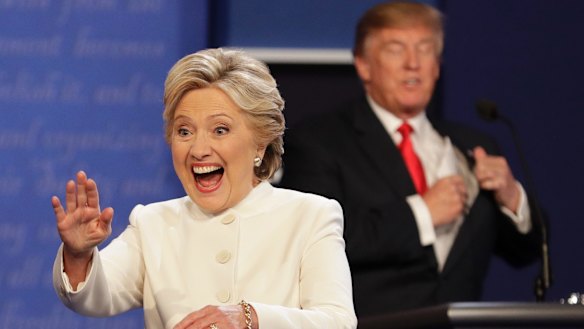 Hillary Clinton waves as Donald Trump puts away his notes at the third presidential debate.