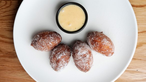 Yeasty, sugar-coated zeppole doughnut balls with vanilla custard.