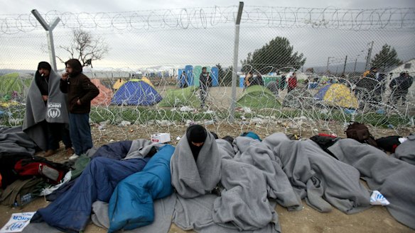 Refugees and migrants who entered Macedonia illegally and were detained by the police wait to be returned to Greece at a checkpoint near Gevgelija, Macedonia.