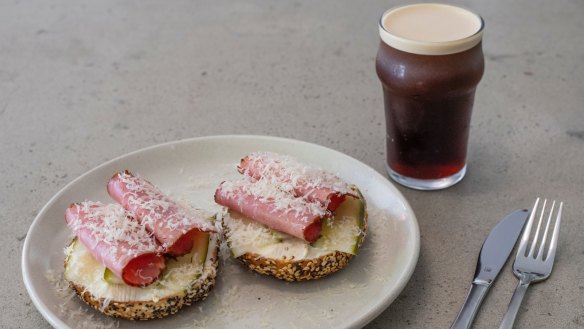 A pastrami bagel with nitro cold brew.