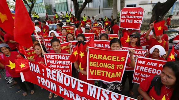 Filipinos and Vietnamese expatriates rally last Thursday at the Chinese consulate in Makati, east of Manila, to protest China's island-building and deployment of surface-to-air missile system in the South China Sea.