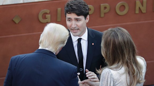 Mr Trump and First Lady Melania, talk with Mr Trudeau as they arrive for a concert in the Sicilian citadel of Taormina.