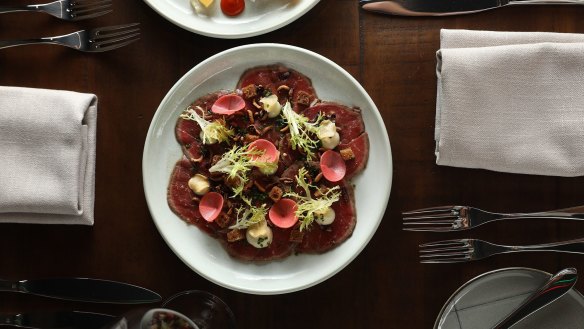 Beef carpaccio with anchovy mayonnaise, shiso dressing, smoked crouton, crispy garlic, puffed wild rice and frisee.
