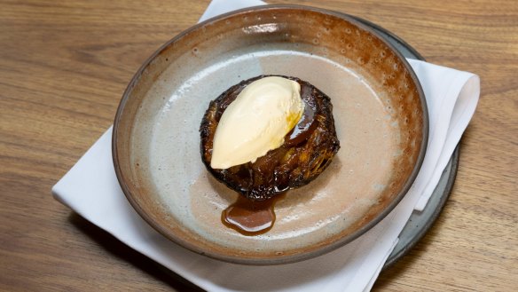 Tarte tatin topped with vanilla ice-cream.