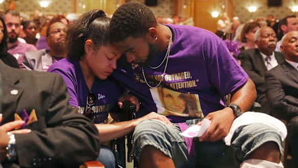 Marcus Martin, right, hugs hugs his fiance Marissa Blair at the memorial. Martin pushed his fiance out of the way of the vehicle that killed Heyer last Saturday. 