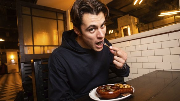 Diner Edgar Rochez eating traditional escargot de Bourgogne at Bar Margaux in Melbourne.